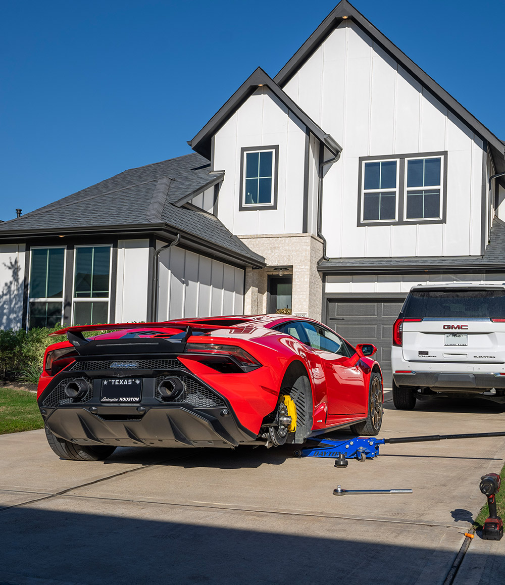 Garage2Go working on a tire for a Ferrari on customer's driveway