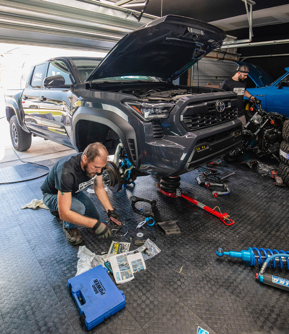 Garage2Go Mechanic installing suspension on a Toyota Tacoma Truck